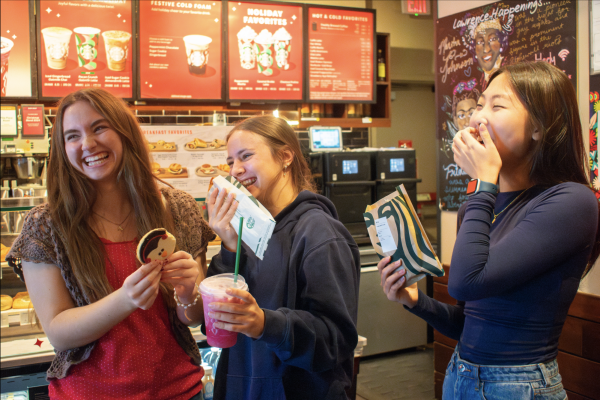 Laughing together, journalism staff members Katie Campbell, Lauren Rosen and Jaehee Kim try items off of the Starbucks holiday menu.